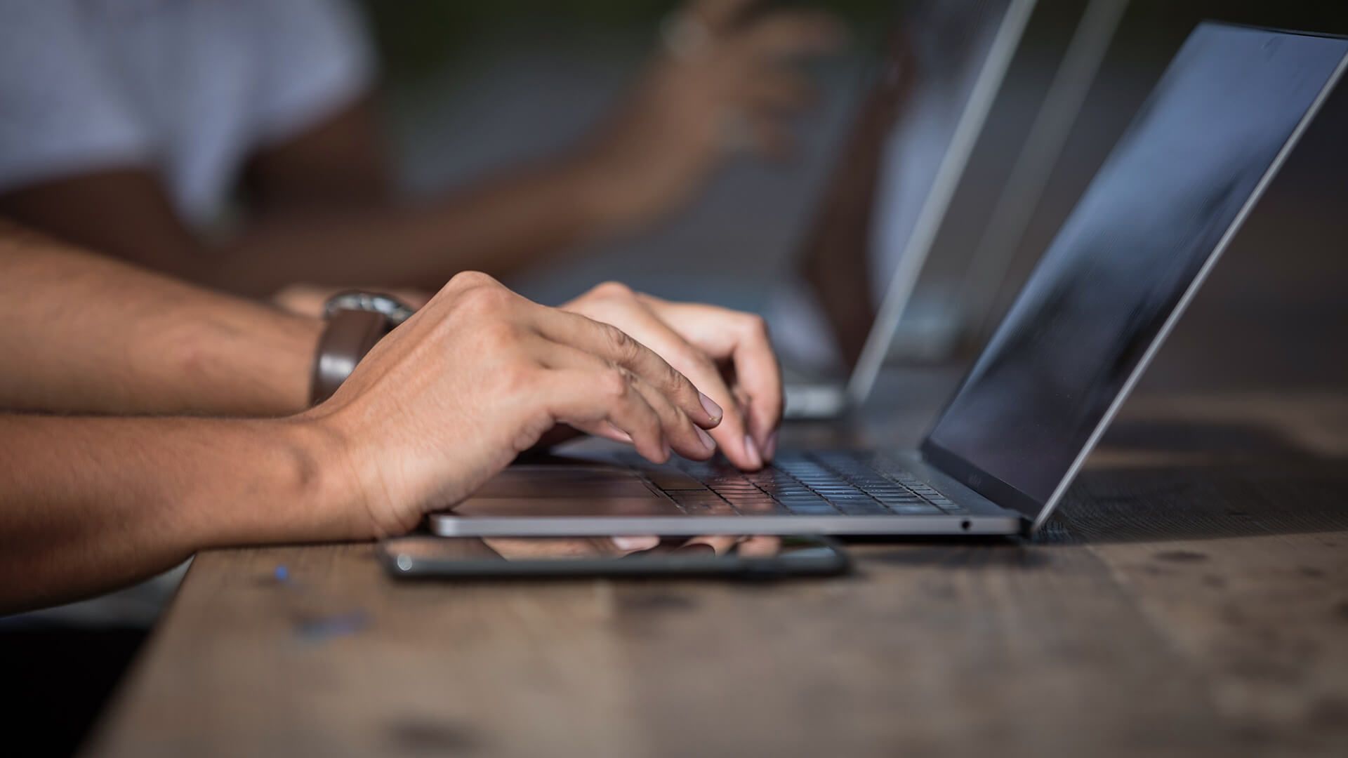 Person logging their time on their laptop